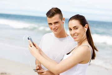 Couple of runners with mobile smart phones outdoors