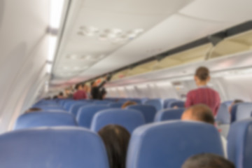 Abstract blurred passenger passengers lifting their carry-on lug