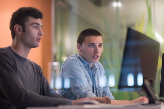 technology students group working  in computer lab school  class