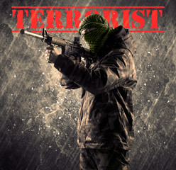 Dangerous masked and armed man with terrorist sign on grungy bac