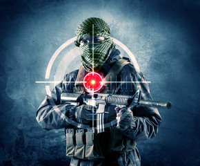 Masked terrorist man with gun and laser target on his body