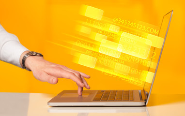 Close up of man typing on laptop computer