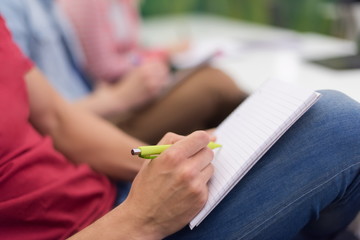 Obraz na płótnie Canvas male student taking notes in classroom
