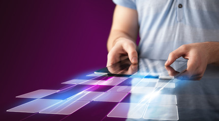 Naklejka premium Close up of hand holding tablet with cyber application
