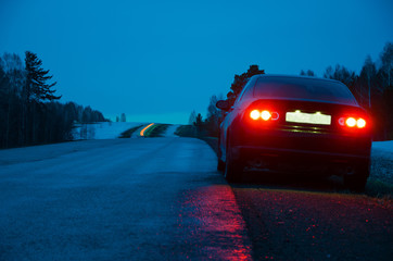 black sports car in the rain at night - 108763094