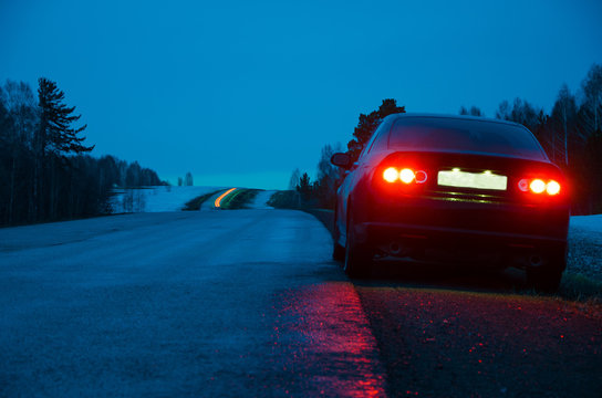 Black Sports Car In The Rain At Night