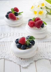 Homemade pavlova meringue cake with fresh berries and whipped cream. Morning. Dessert.