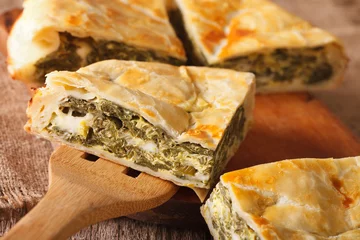 Fotobehang Greek pie with spinach and cheese spanakopita close-up. horizontal   © FomaA