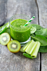 fresh green smoothie on wooden surface