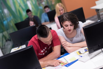 technology students group working  in computer lab school  class