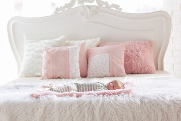 Fototapeta na wymiar newborn baby on large bed