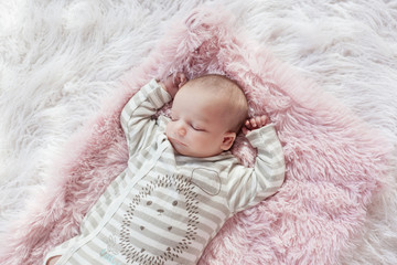 baby sleeping on fur