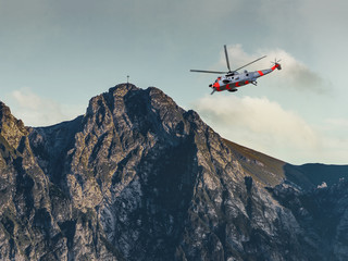 Fototapeta na wymiar Helicopter on a rescue mission in the Tatras Mountains.