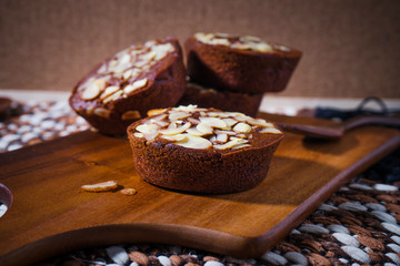 Homemade delicious fresh chocolate and almonds cake on wooden ta