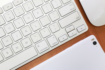 overhead of office table with gadget, computer keyboard and mouse