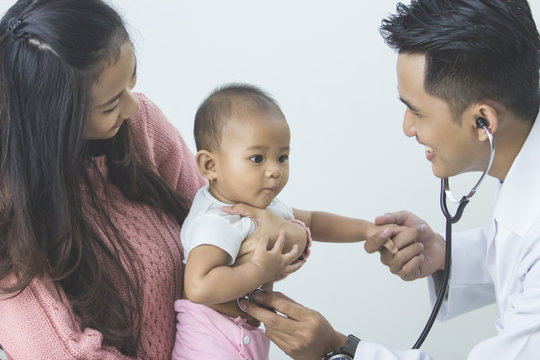 baby being checked by a doctor