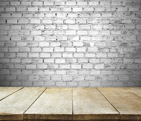 image of wooden table in front of empty white brick textured wal