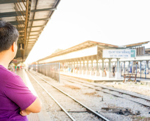 Asian man waiting for train