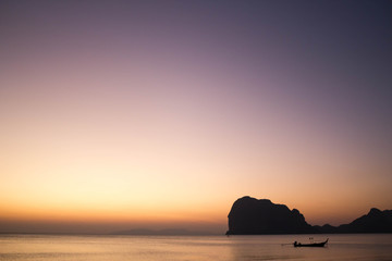 Naklejka na ściany i meble photo of the beach at evening and long tail boat