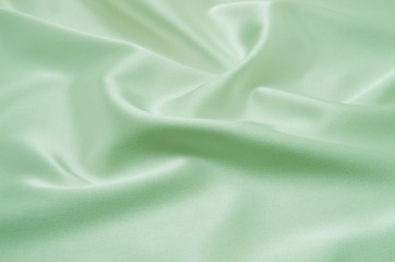 Obraz premium Green satin fabric as background
