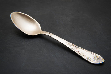 Vintage metal spoon on dark background