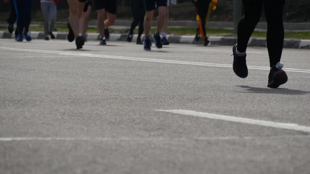 City marathon. Feet of people. Legs of runners on the city street. Crowd of runners feet at marathon race   Close Up 