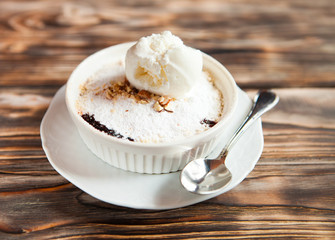 Tasty dessert with an ice cream ball on a wooden background