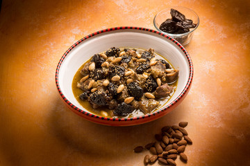 tajine with meat plum almond and sesame seeds