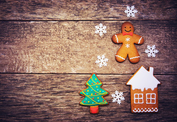 Gingerbread cookies over wooden background