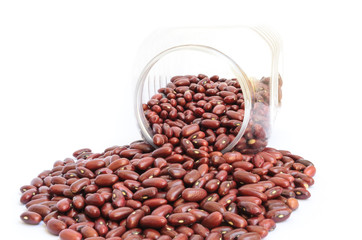 Red beans out of a jar on white background