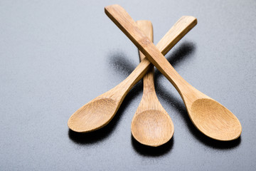 wooden spoons on black table