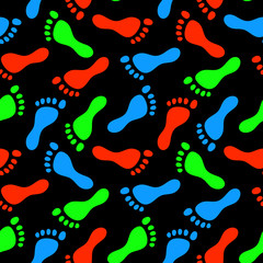 Fototapeta na wymiar Colorful fluorescent human footprints on black seamless pattern, vector