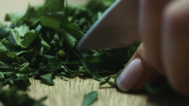 Cutting parsley with a knife closeup
