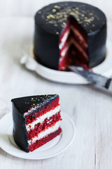 Round black cake with striped red and white filling