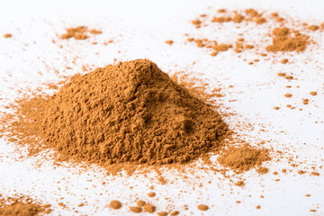 cinnamon powder on white table