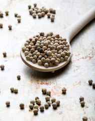 white peppercorn seeds on steel plate