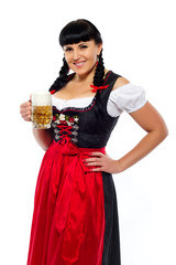 Beautiful brunette woman in Bavarian dressed with glass of beer