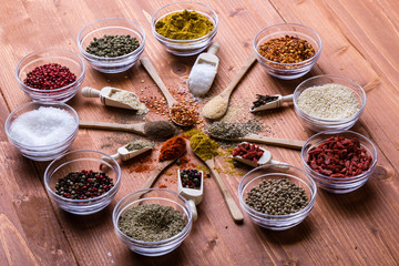 diferent color spices on wooden table