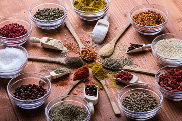 diferent color spices on wooden table