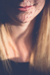 Close up portrait. Woman mouth with flower shadows.