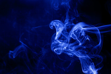Blue smoke on a black background.