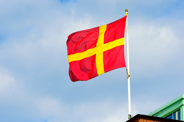 The red and yellow regional flag of Scania or Skane in Sweden.