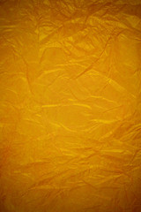 Crumpled gold paper recycling background.