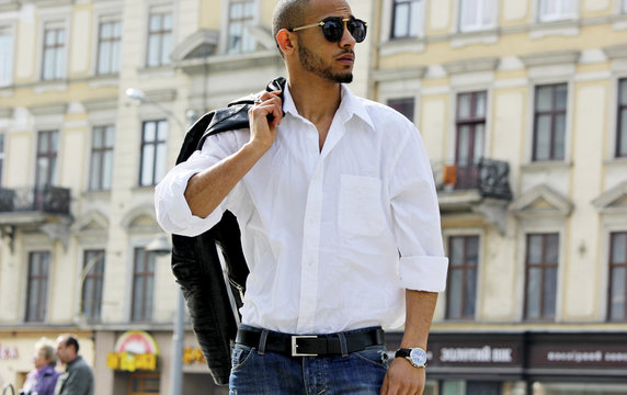 Fashion stylish young african man in sunglasses and black rock leather jacket.