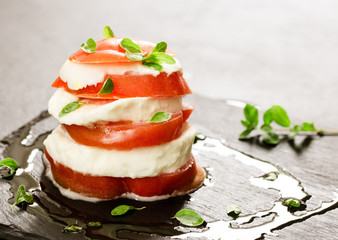 italian caprese with marjoram over slate