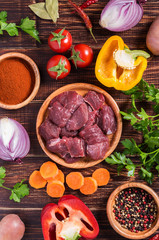 Ingredients for goulash or stew cooking: raw meat,herbs,spices,v
