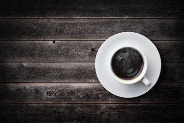 a cup of coffee on vintage wooden table
