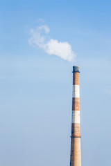 Industrial power plant smoke pollution in the blue sky