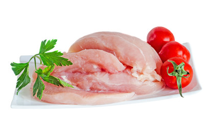 Chicken raw meat on a white plate, decorated with green parsley