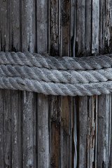 Old rope on textured vintage wooden wall